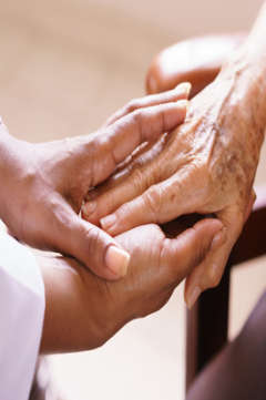 nurse holding a patient's hand