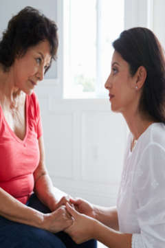 woman with dementia holding hands with her daughter 