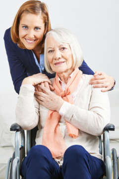 caregiver with senior woman in wheelchair