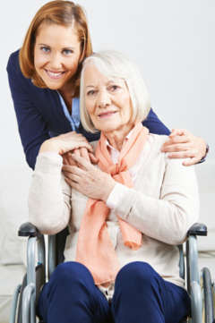 caregiver with senior woman in wheelchair 