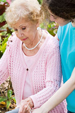 nurse helping woman walk