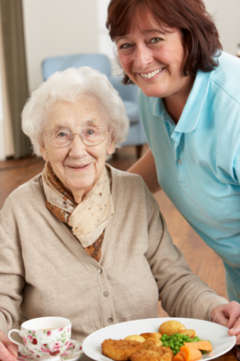 senior woman being served dinner 