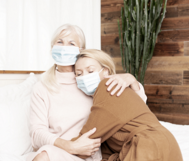 young woman visiting grandmother with masks