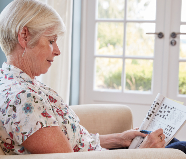 senior woman doing crossword puzzle