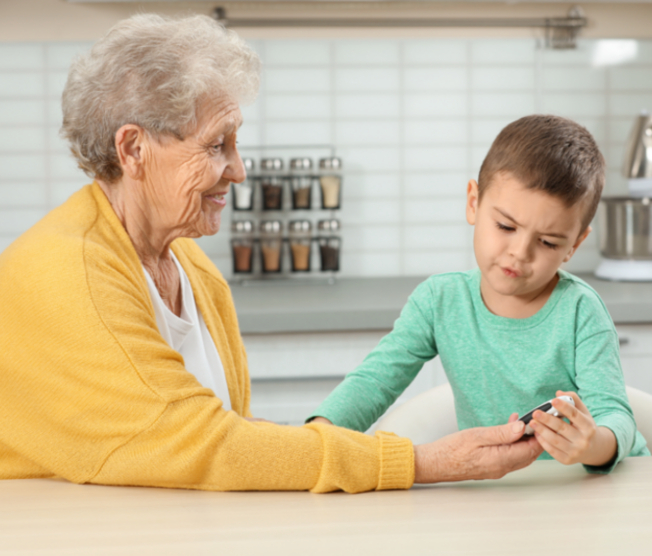 boy holding woman's glucose meter
