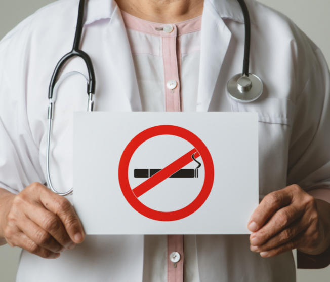 doctor holding quit smoking sign