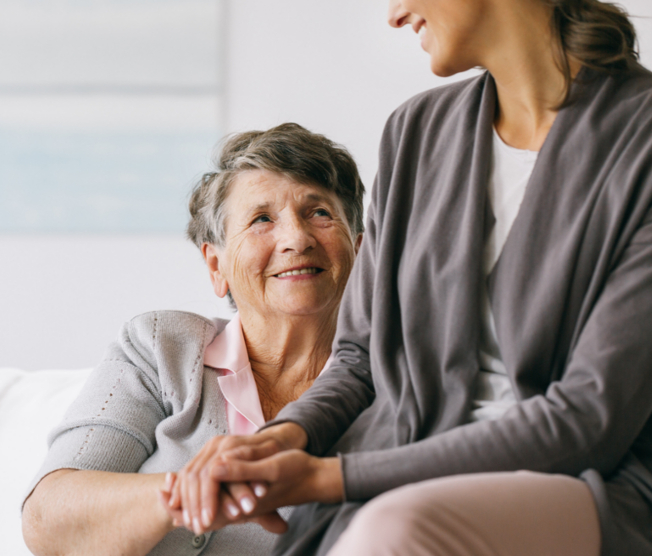 mother holding adult daughter's hand