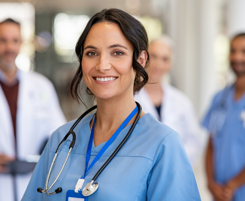 happy nurse with healthcare team in background