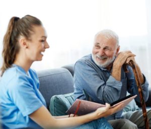 caregiver with senior man in nursing home