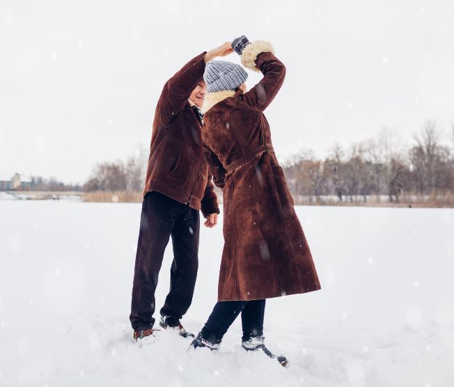 senior couple dancing outdoors in winter weather