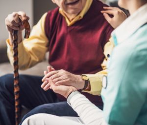 caregiver assisting old man