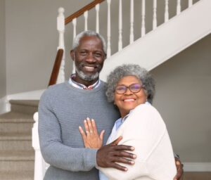 senior couple posing by staircase
