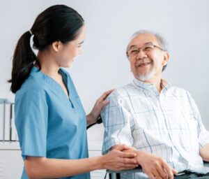 nurse smiling at a happy senior patient