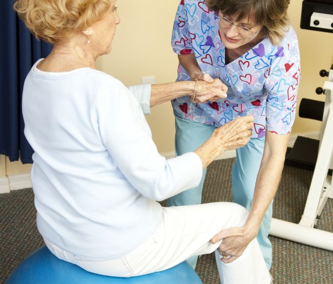 senior woman working with a physical therapist