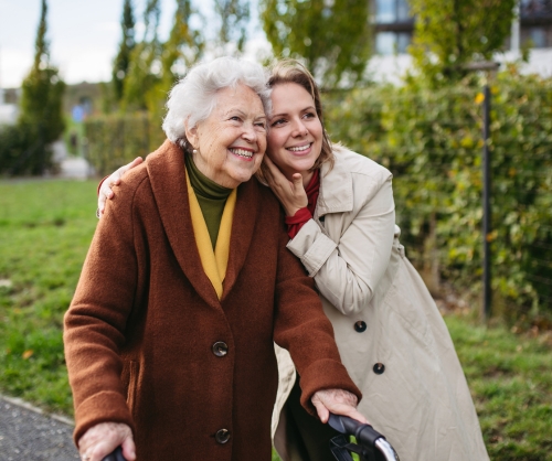 older woman with smiling caregiver