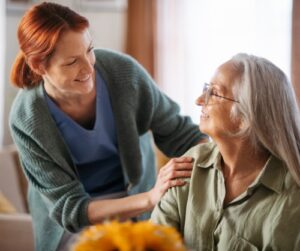 smiling caregiver supports senior woman